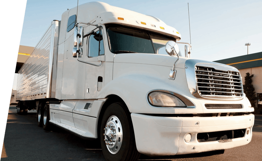 A white truck is parked on the side of the road.