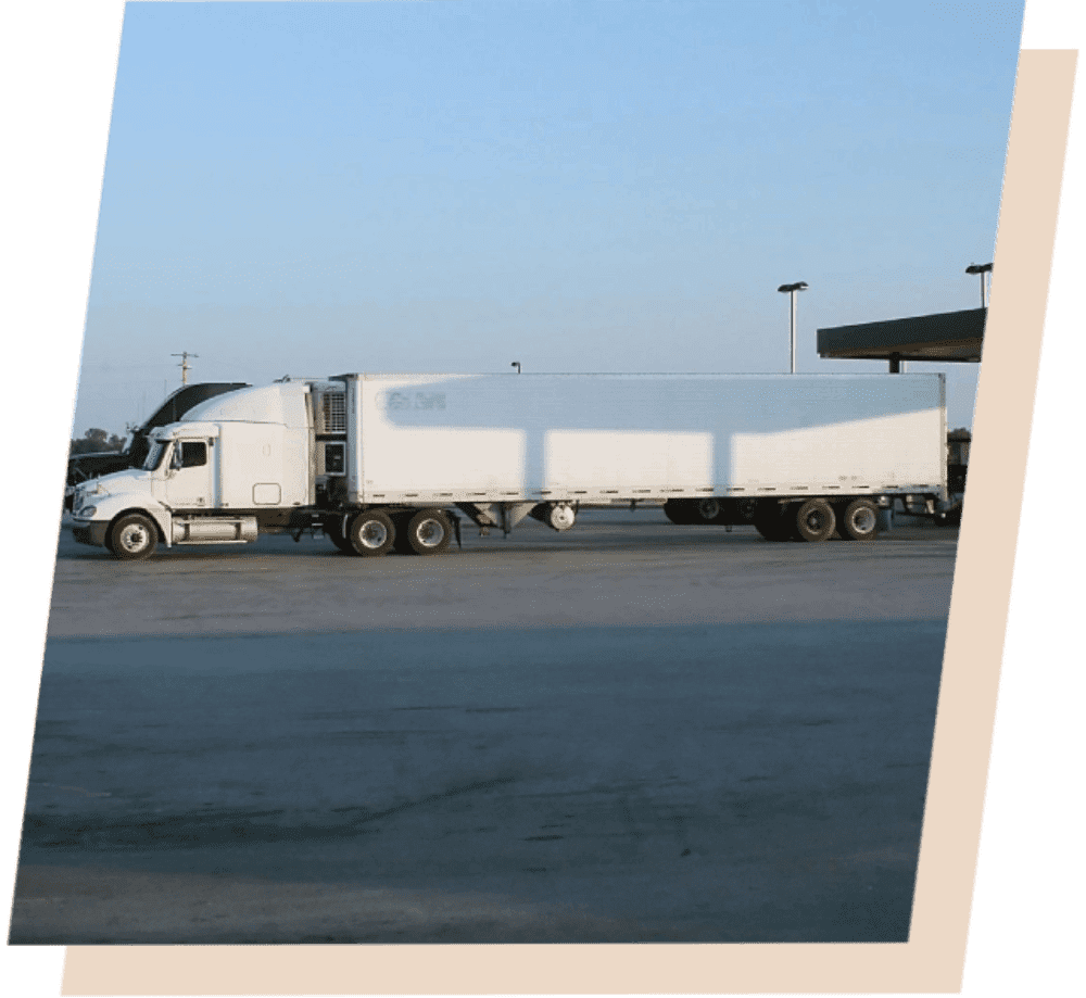 A large white truck parked in the parking lot.